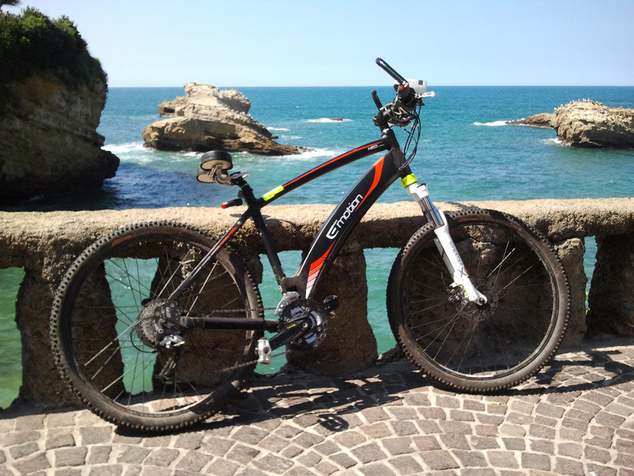 Noseless bike seat that is a prostate safe bike seat adorns an EMotion electric mountain bike on a Mediterranean shoreline!